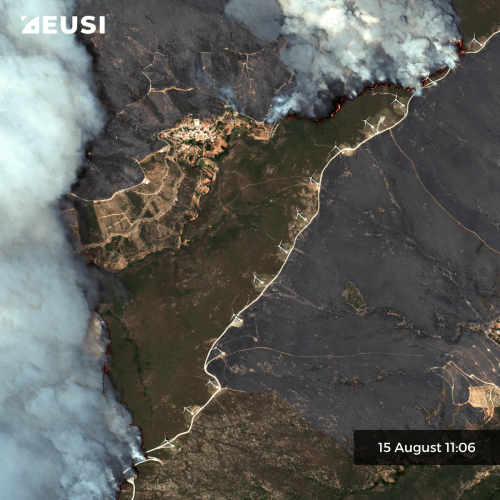 Very high resolution satellite image of a progressing fire on 15 August 11:06. The fire line is visible in the west, far away from a village and a road.