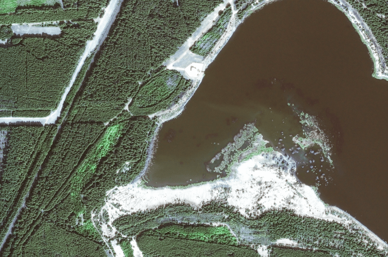 Satellite image of a water reservoir with material from a landslide in the water